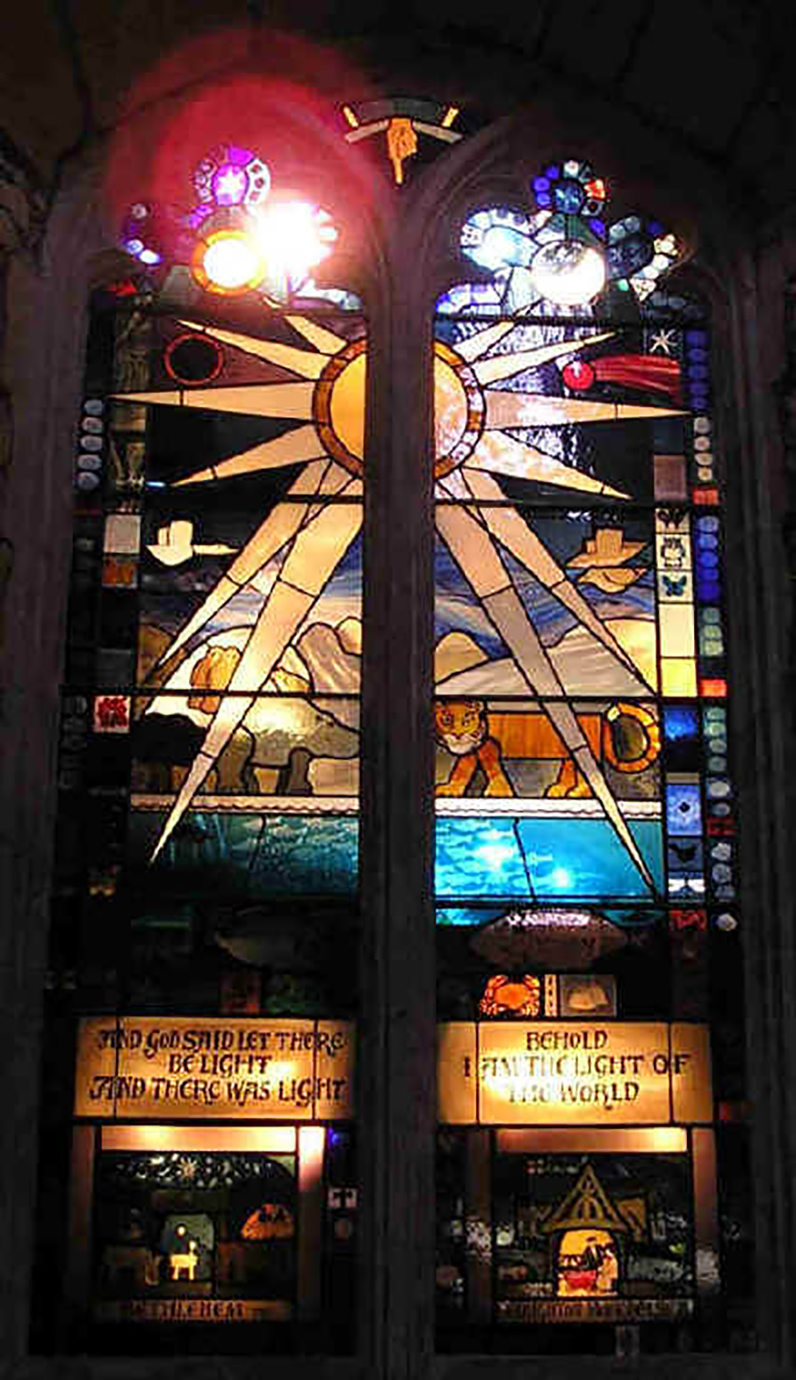 The Millennium Window lit from behind: a great star bursting over hills, sea, a tiger and other creatures, with Bethlehem at the bottom left and Boughton Monchelsea at the bottom right