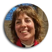 Revd Hollie Butler, smiling, wearing a clerical collar